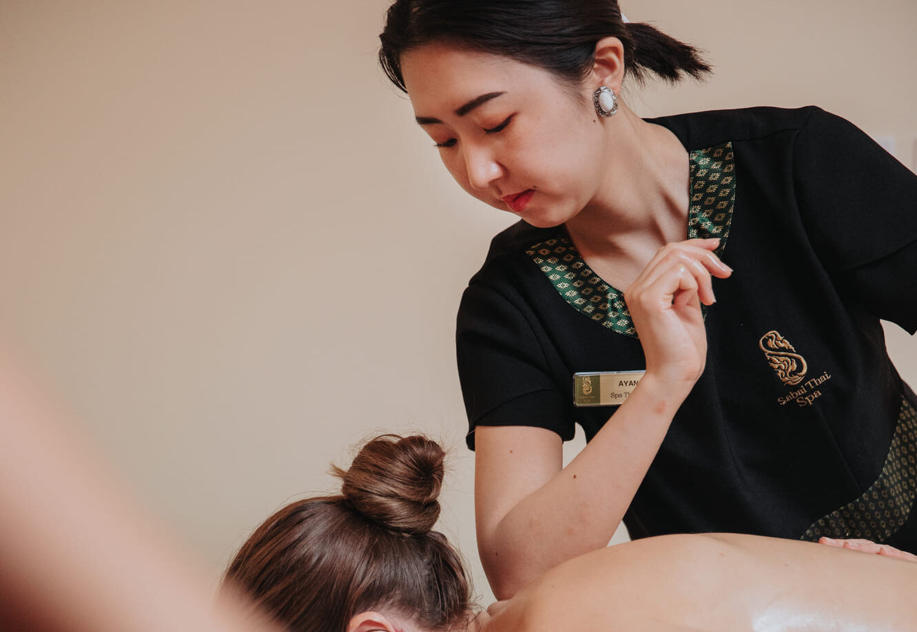 Asian therapist in the middle of massage at Sabai Thai spa
